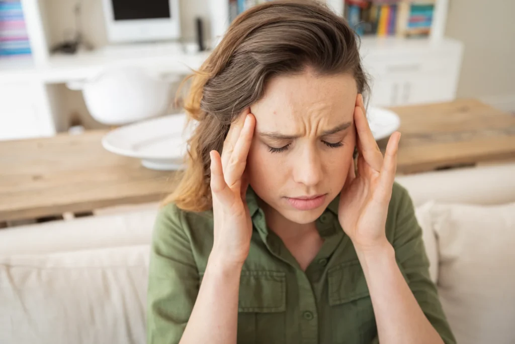 woman massaging temples suffering from headache in 2026 03 25 01 33 07 utc