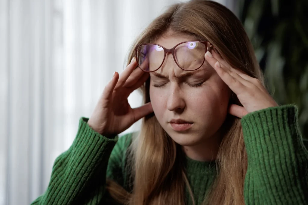 young woman experiencing stress with hands on head 2026 03 25 06 59 12 utc